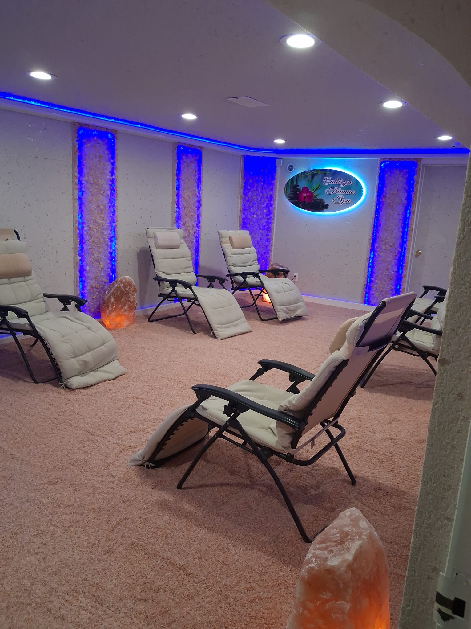 Himalayan salt room at Cattleya Trianae Spa with illuminated spa sign and reclining chairs