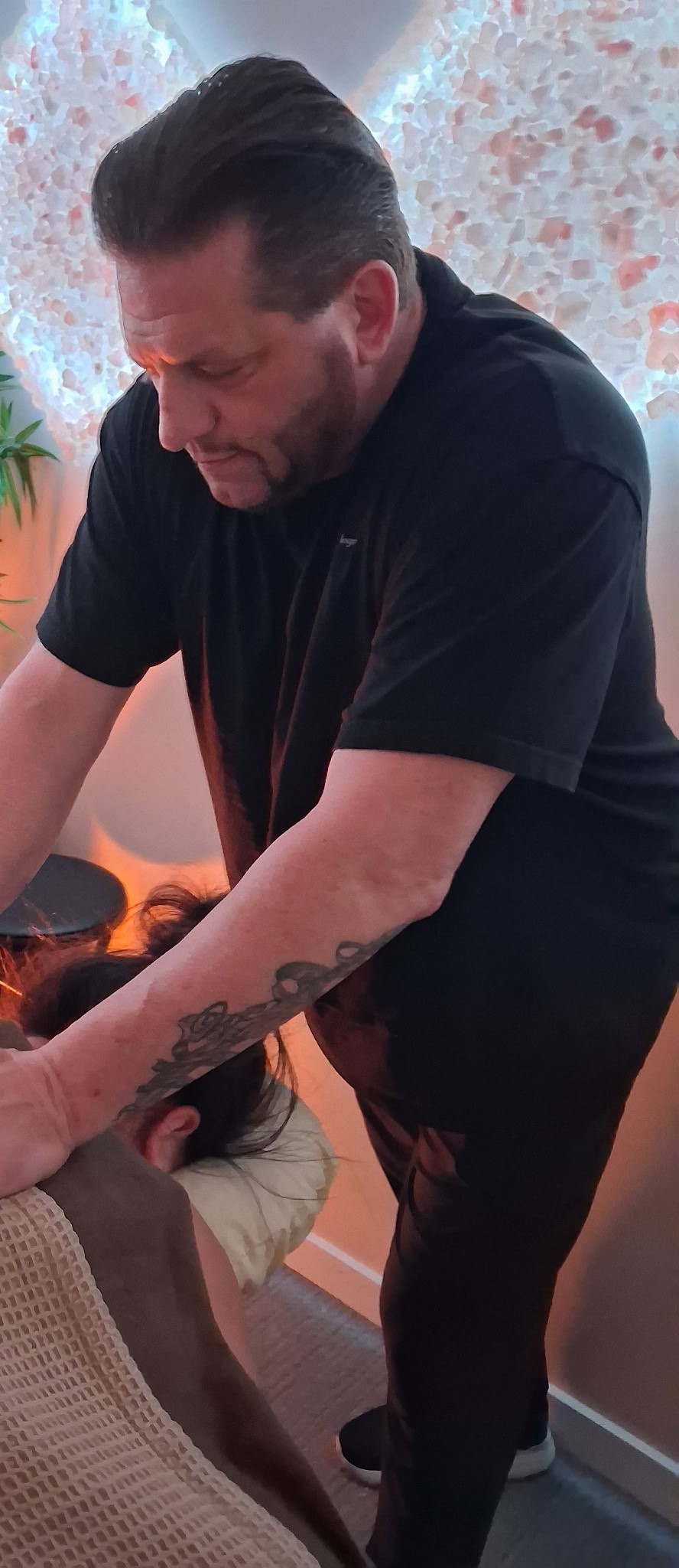 Anthony providing hands-on massage therapy during a client session