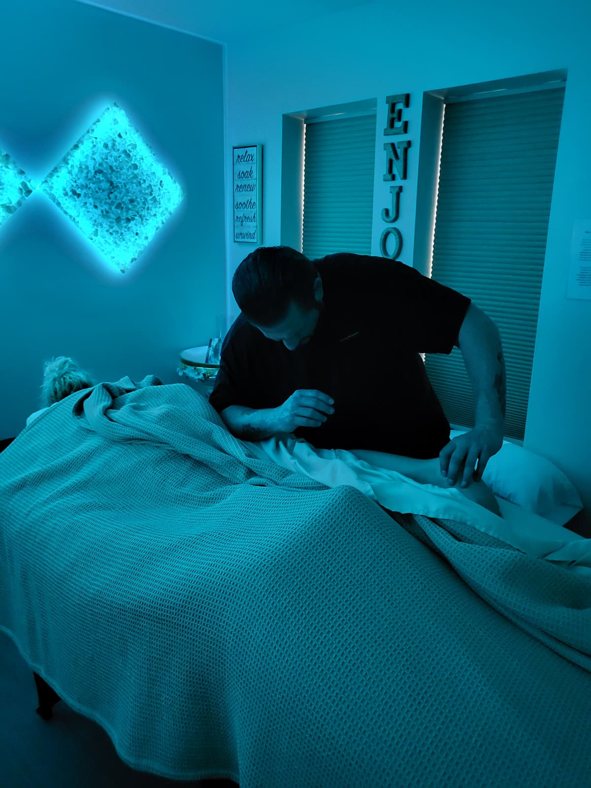 Anthony providing attentive hands-on therapeutic bodywork during a client session